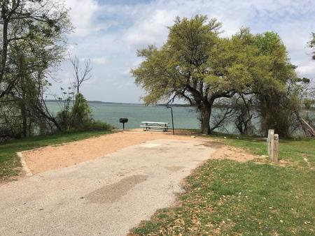 RV site with picnic table, grill, fire ring, and great view of Waco Lake