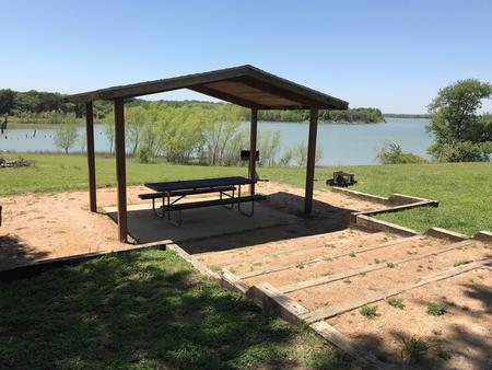 Covered picnic table, grill, and fire ring with great view of Waco Lake