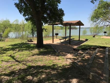Covered picnic table, grill, and fire ring with great view of Waco Lake