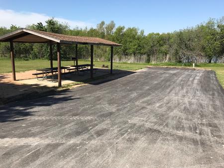 Double RV site with covered picnic tables, grill, and fire ring