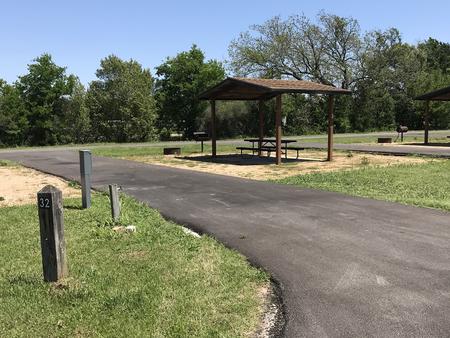 Pull through RV site with covered picnic table, grill, and fire ring