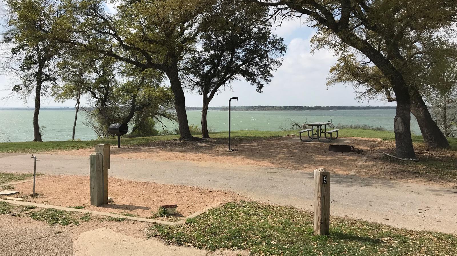 Pull through RV site with picnic table, grill, fire ring, and great view of Waco Lake