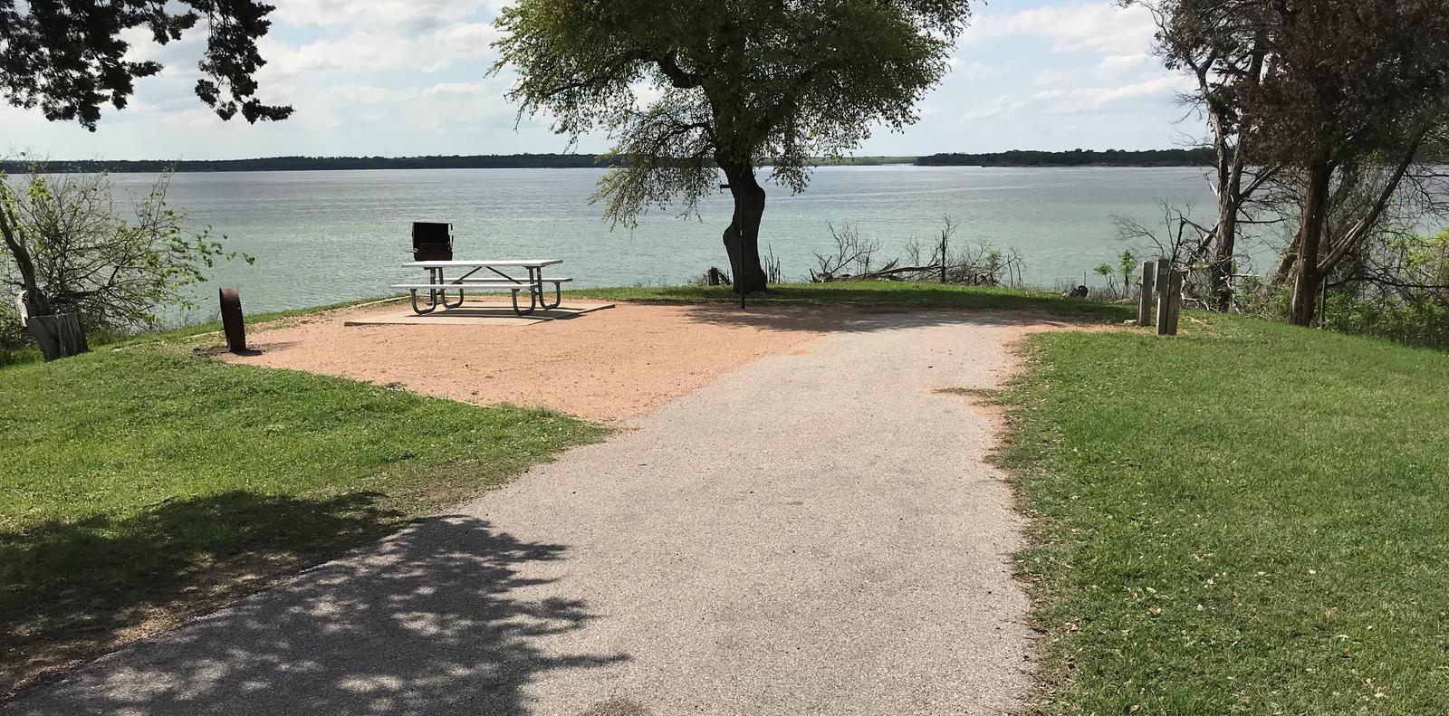 RV site with picnic table, grill, fire ring, and great view of Waco Lake