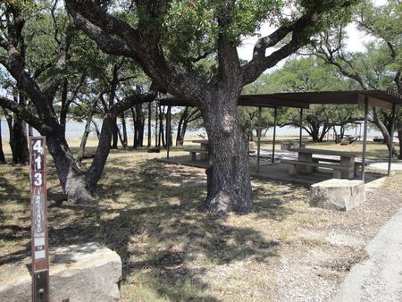 A photo of Site 413 of Loop 4 at FLATROCK (TEXAS) with Picnic Table, Electricity Hookup, Fire Pit, Shade, Waterfront, Water Hookup