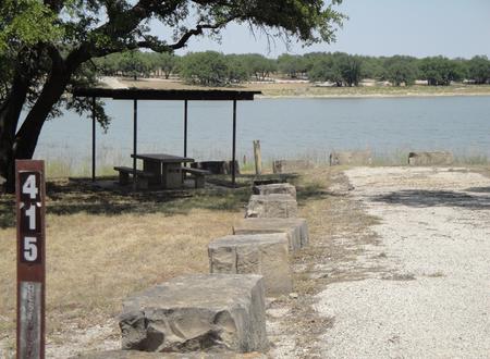 A photo of Site 415 of Loop 4 at FLATROCK (TEXAS) with Picnic Table, Electricity Hookup, Fire Pit, Shade, Waterfront, Water Hookup