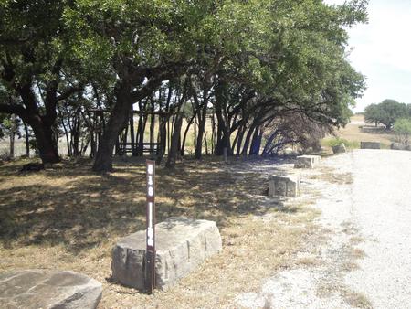 A photo of Site 418 of Loop 4 at FLATROCK (TEXAS) with Picnic Table, Electricity Hookup, Fire Pit, Shade, Water Hookup