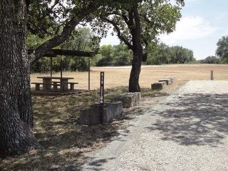 A photo of Site 419 of Loop 4 at FLATROCK (TEXAS) with Picnic Table, Electricity Hookup, Fire Pit, Shade, Water Hookup