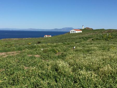 terrace overlooking ocean, two buildings, and lighthouse.Anacapa Island