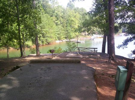Paved back in spot, picnic table, water view.Sawnee site 3