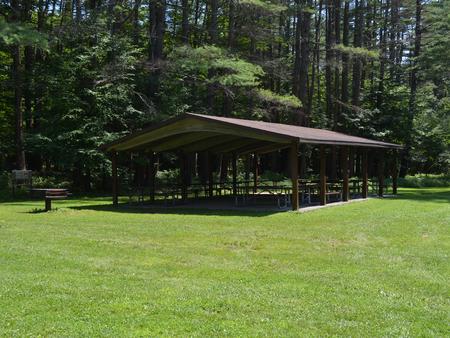 Pine shelter, and lawn area with grill and picnic tables at Otter Brook LakePine Shelter at Otter Brook Lake
