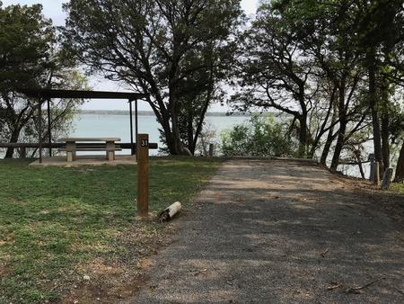 RV site with covered picnic table and Waco Lake in the background