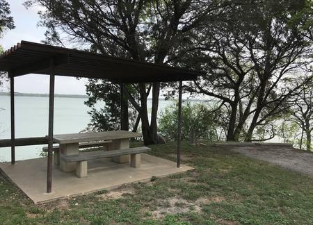 Covered picnic area at site with Waco Lake in the background