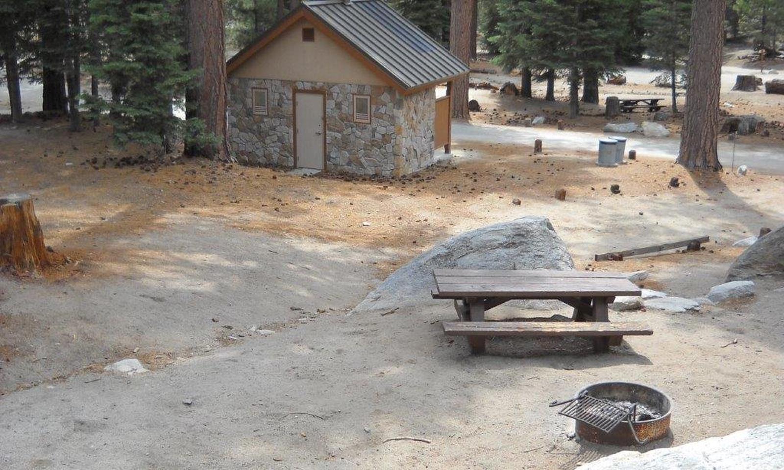 Boulder Basin campsite 3 with picnic table, fire ring, and restroom.