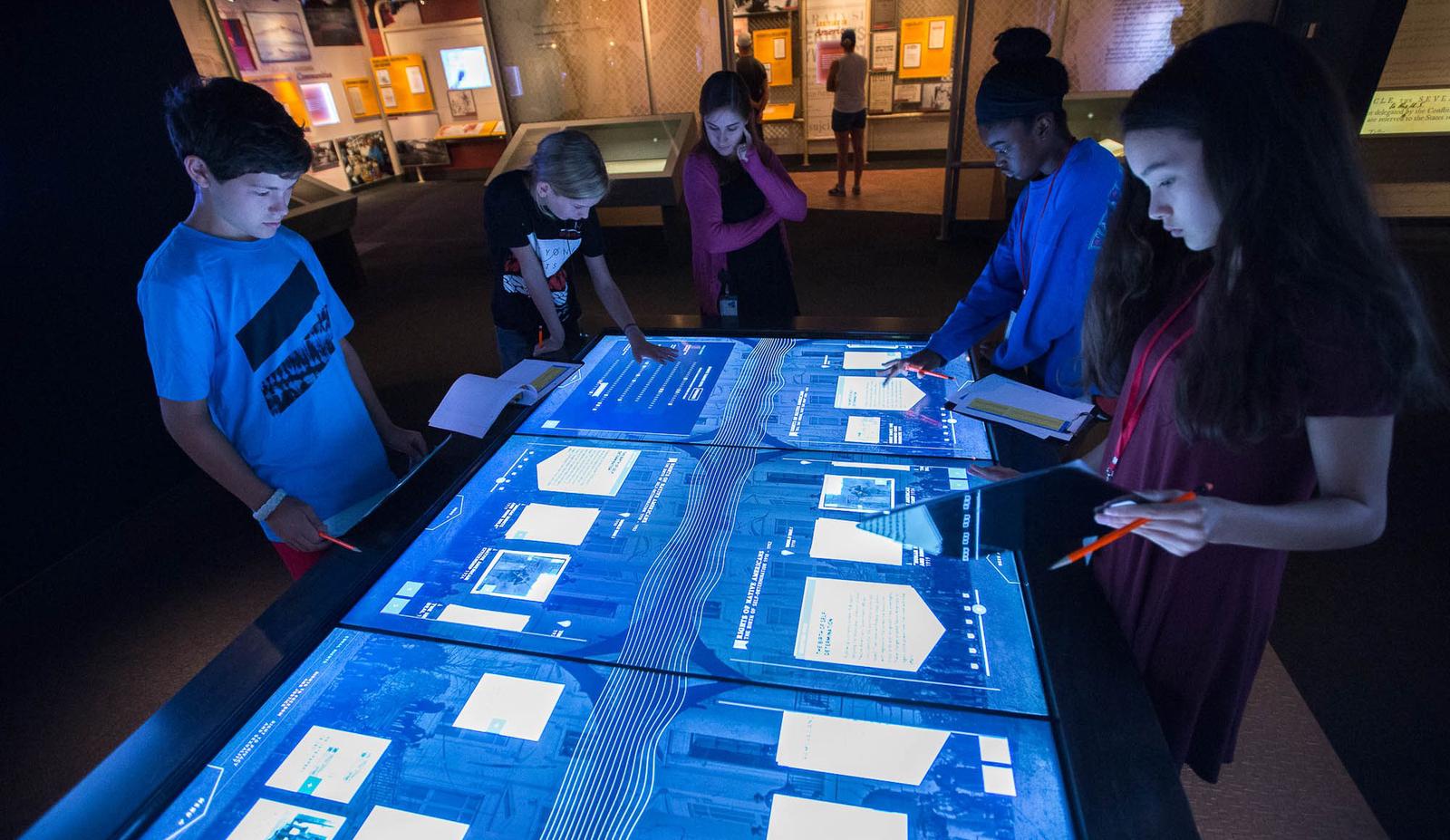 Visitors exploring records on an interactive table