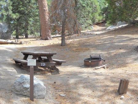 Boulder Basin campsite 13 with picnic table and fire pit.