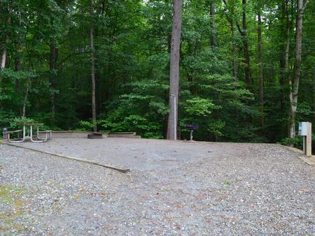 Gravel site with fire pit, table, grill and lake view 