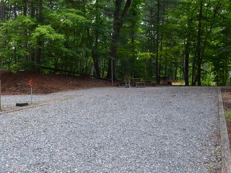 Gravel site with fire pit, table, grill
