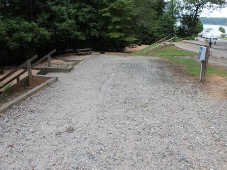 Long gravel pull in with steps going down to site 