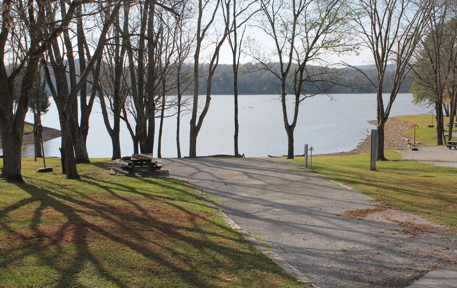 A photo of Site 022 of Loop LAKE at DEFEATED CREEK PARK with Picnic Table, Electricity Hookup, Fire Pit, Shade, Waterfront, Lantern Pole, Water Hookup