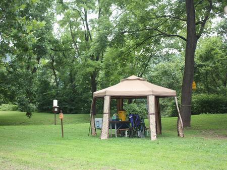 Campsite with pop-up tent over picnic table