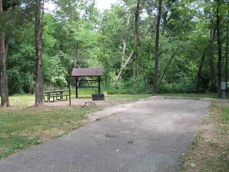 Campsite 11 showing parking spur, picnic table, lantern post, food shelter, fire ring and electric hookup.Campsite 11