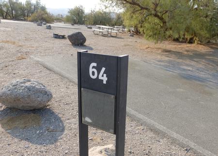 Furnace Creek Campground standard nonelectric site #64 with picnic table and fire ring.