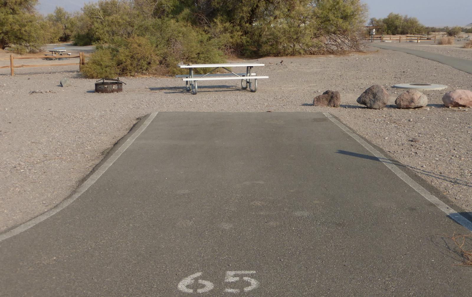 Furnace Creek Campground standard nonelectric site #65 with picnic table and fire ring.