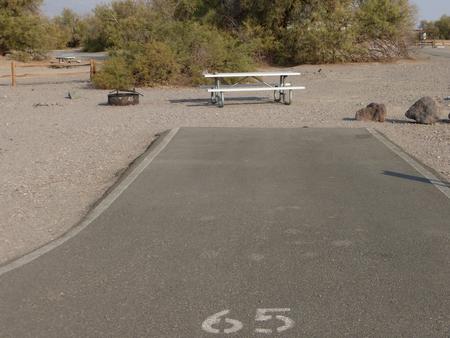 Furnace Creek Campground standard nonelectric site #65 with picnic table and fire ring.