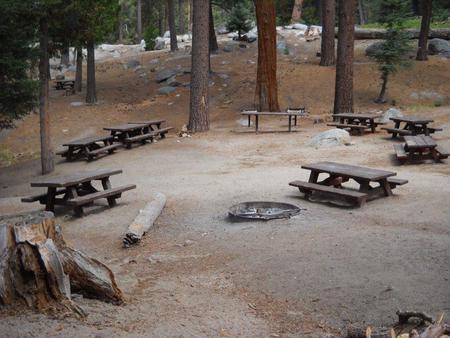 Campsite with benches with firepit.
