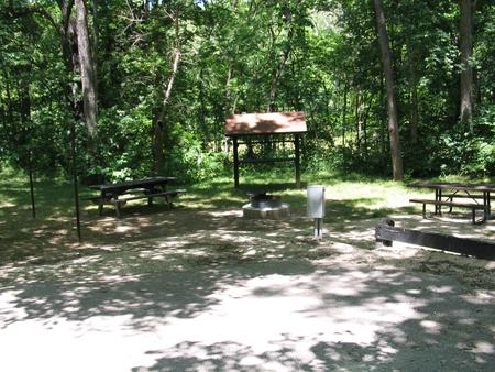Campsite 27 showing parking spur, picnic tables, lantern posts, food shelter, electric hookup and fire ringCampsite 27