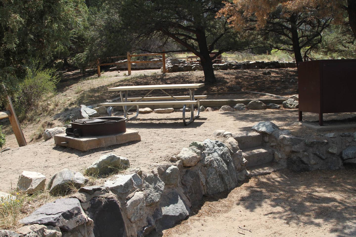 View of site #13 designated tent pad, fire ring, picnic table, and bear box.Site #13, Pinon Flats Campground