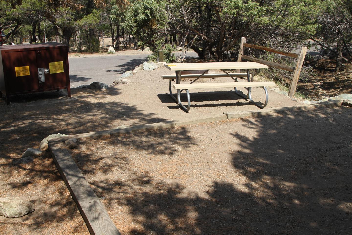 Back view of Site #13 designated tent pad, picnic table, bear box, and fire ring. Road and parallel parking can be seen in background.Site #13, Pinon Flats Campground