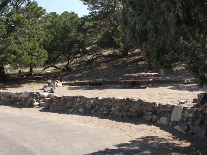 View of Site #61 parallel parking area and tent site, with picnic table and fire ring. Tent site sits on side of hill and experiences water runoff during heavy rains.Site #61, Pinon Flats Campground