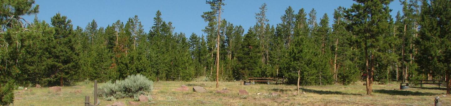Picnic table and fire pit in a group site.Browne Lake Campground: Group Site 2