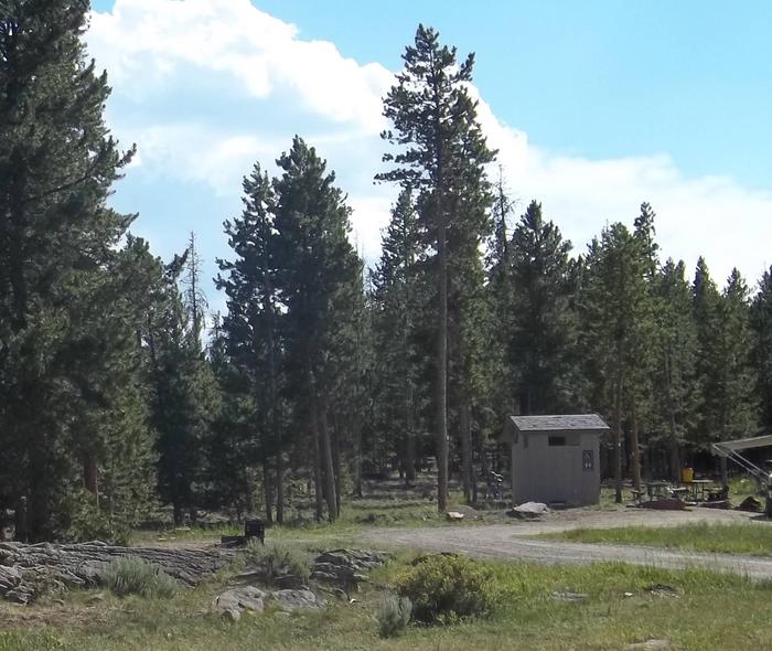 Restroom and picnic tables that are located in a group campground.Browne Lake Campground: Group Site 4