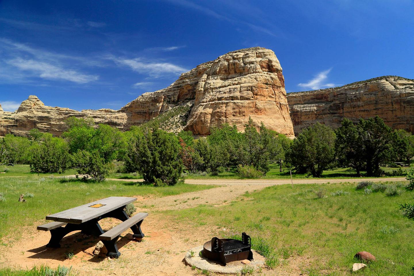 A picnic table at a campsite in Echo Park Campground with Rock Formations in the backgroundEcho Park Campsite