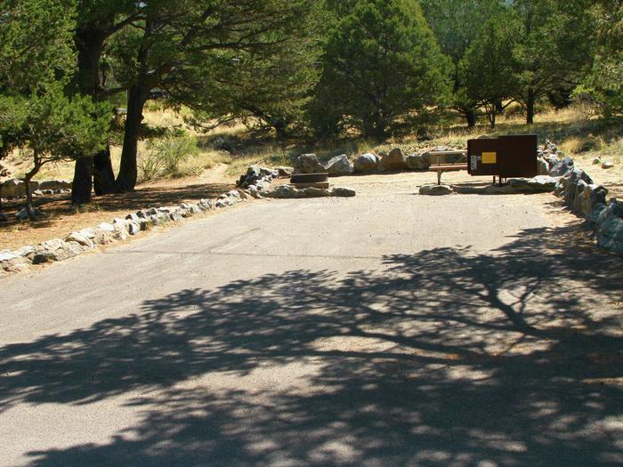 View of Site #75 parking pad and tent site with bear box, picnic table, and fire ring. Site has some tree shade on parking pad.Site #75, Pinon Flats Campground