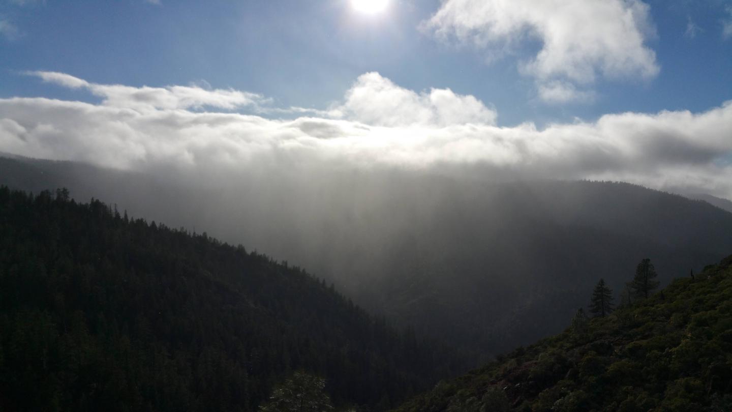View of mountains, clouds, sun.One of the many beautiful views guests might see on the way to the cabin.