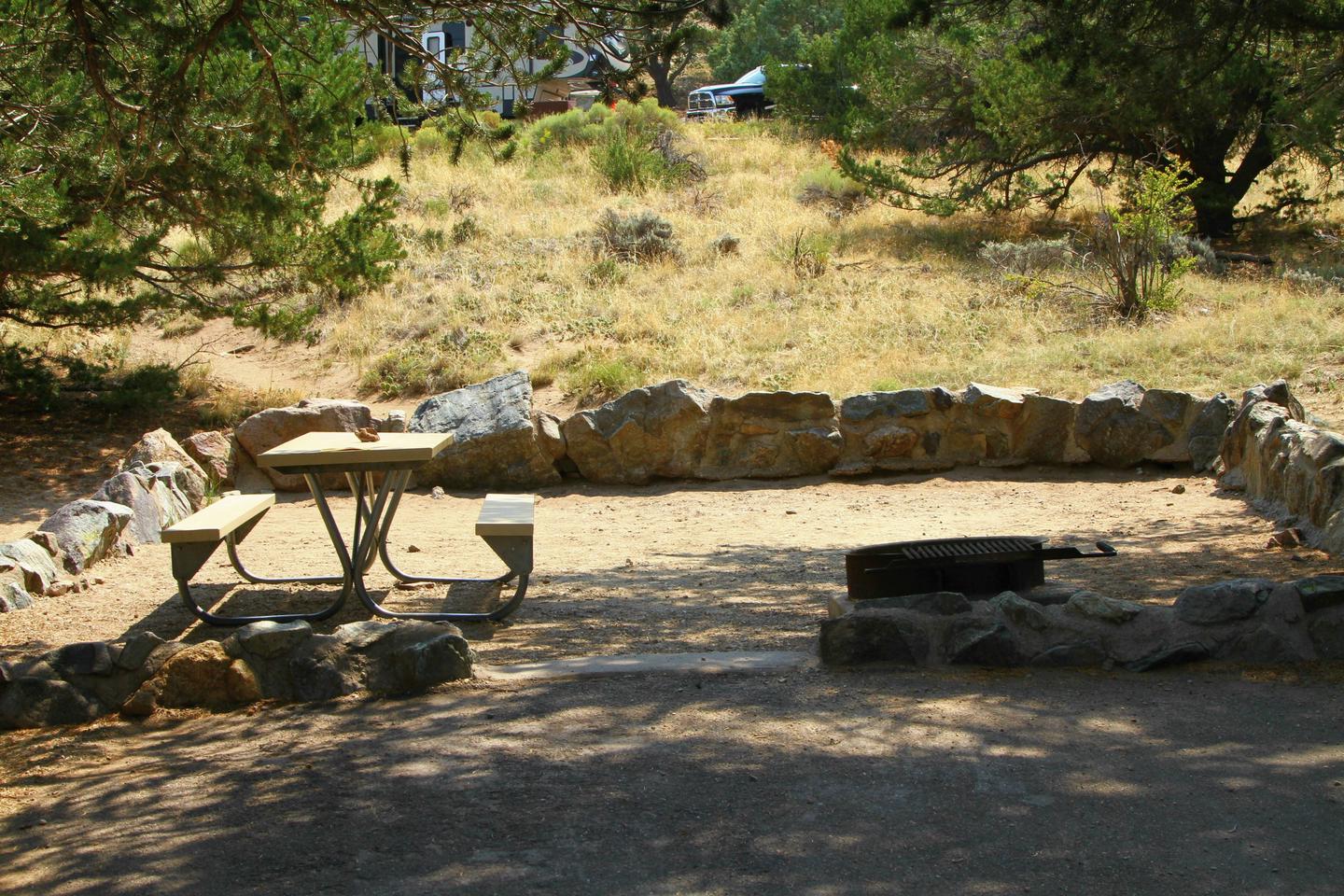 Closer view of Site #73 tent pad, with picnic table and fire ring. Tent pad is bordered by a low rock wall.Site #73, Pinon Flats Campground