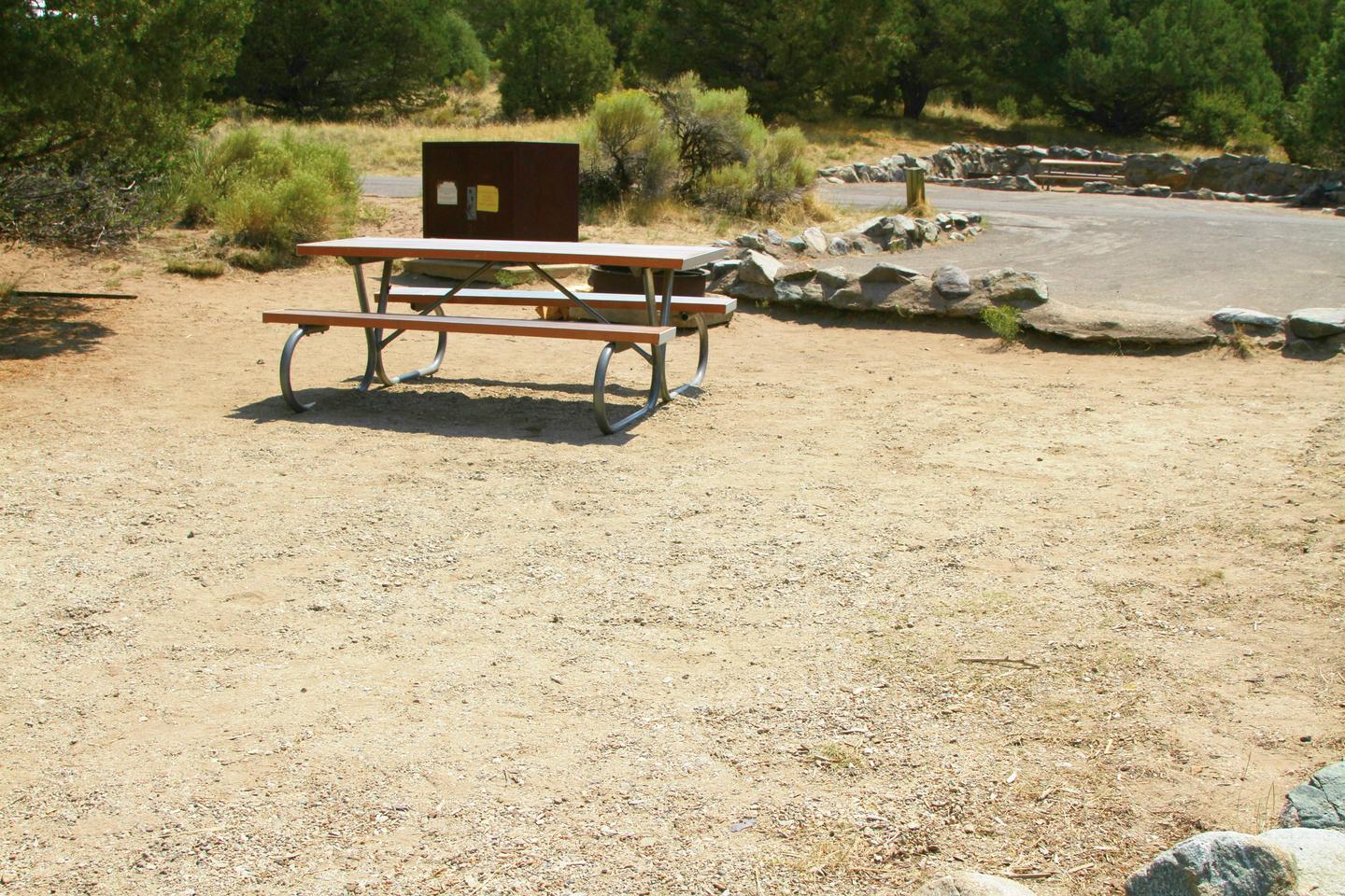 Back view of Site #57 tent pad with picnic table, bear box, and fire ring.Site #57, Pinon Flats Campground