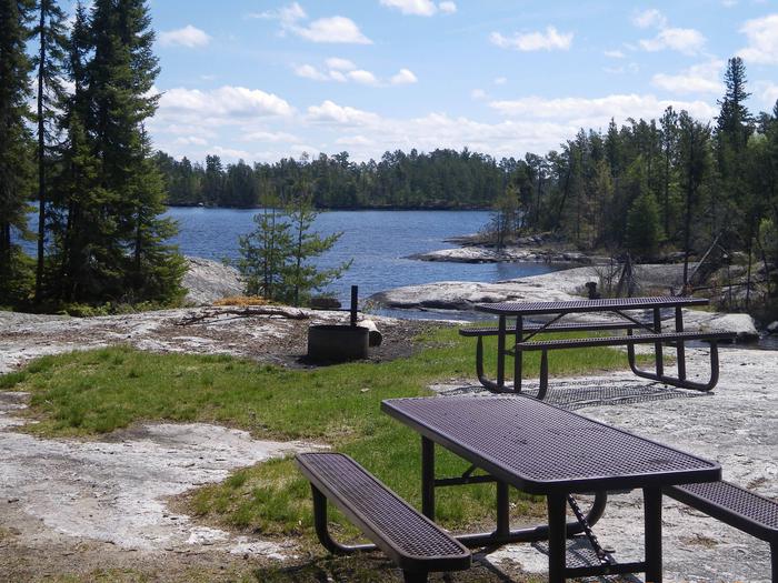 R5 - Big Island, scenic view from campsite with a couple of picnic tables in the foreground.R5 - Big Island campsite on Rainy Lake