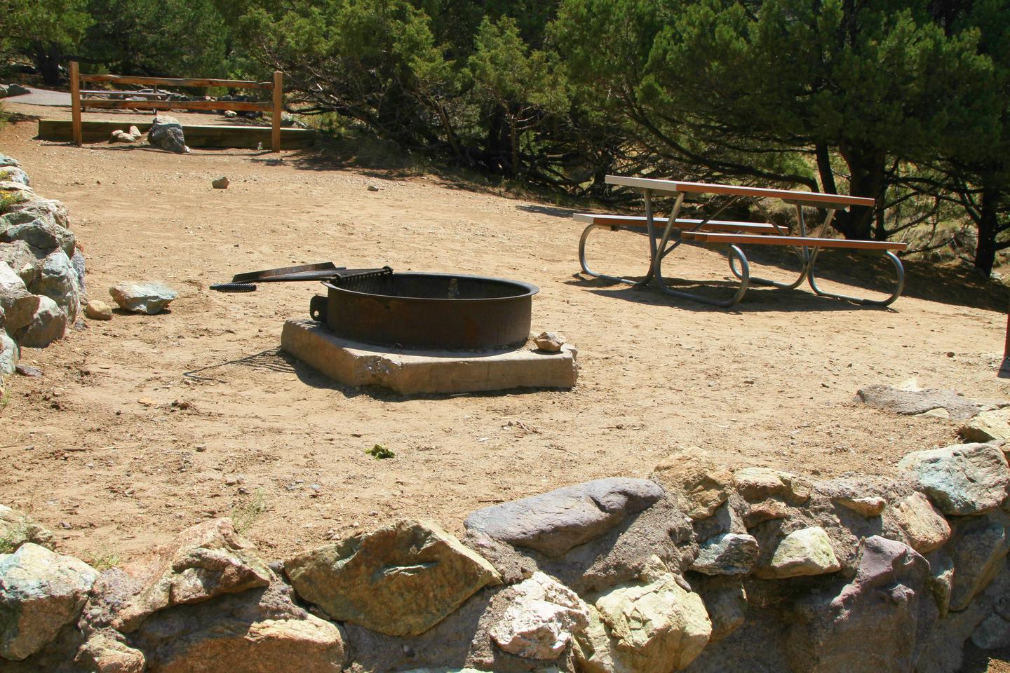 Close up view of site #85 tent pad with fire ring and picnic table. I cannot stress how Sites #85 and #48 are essentially the same site but with a flimsy fence trying to make them seperate.Site #85, Pinon Flats Campground