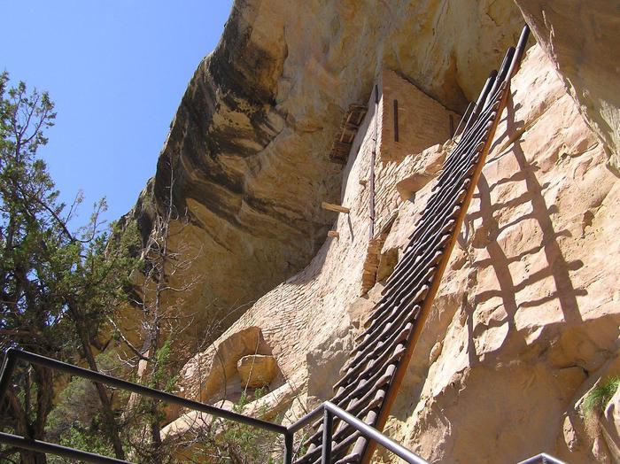 32-foot wooden ladder leaning on cliff wall