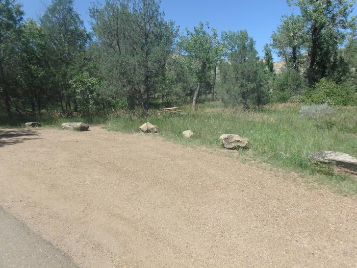 Camping pad is lined with boulders, being a left hand pull off site, your door will open into the roadway. Site 13. Note the picnic table is on the left side while your door is on the right side.