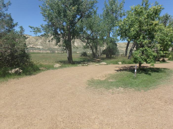 Site 21, boulders are along the outer edge. This site has views of the river as well. Site 21. This site is a left handed pull through, meaning your RV door will open on the road side, opposite of your picnic table and grill.  