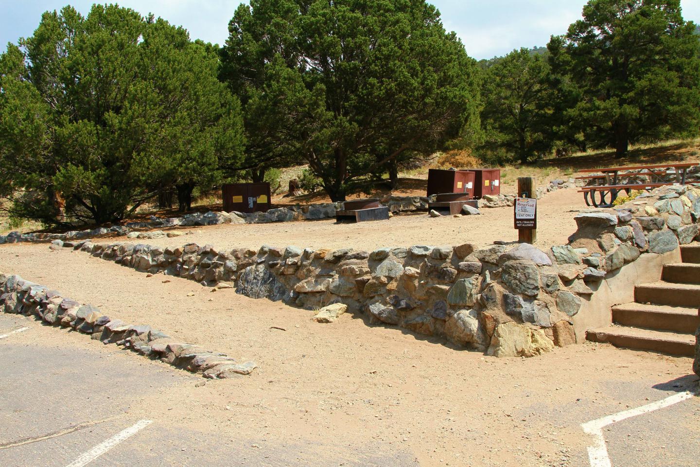 Close up view of Group Site "C" accessible gravel ramp. Bear boxes, fire rings, and picnic tables can be seen in the background.Group Site C, Pinon Flats Campground