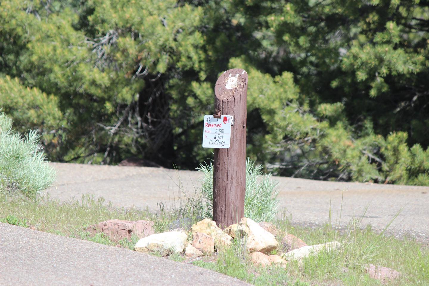 Post at the entrance of the site that shows it being reserved.Cedar Springs Campground: Site 8