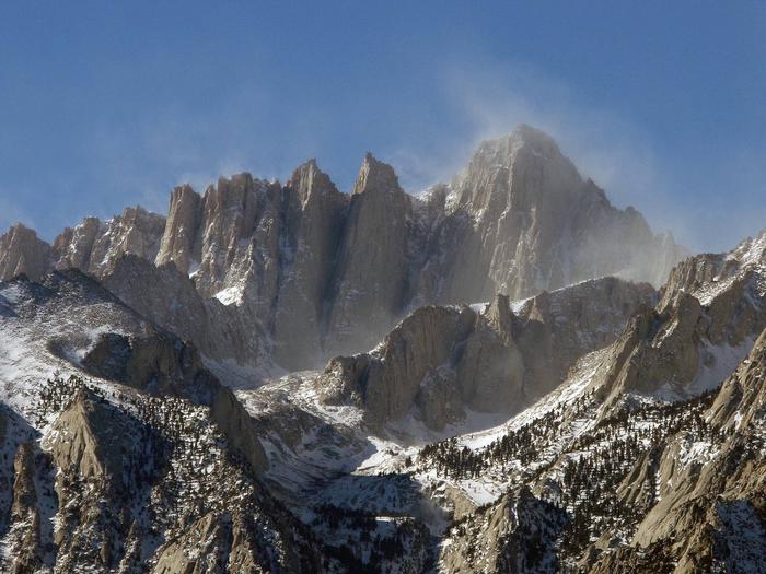 Spindrift from the summit of Mount Whitney. The beautiful veil of snow blowing from the summit also indicates the extreme conditions that may be encountered on Mount Whitney.