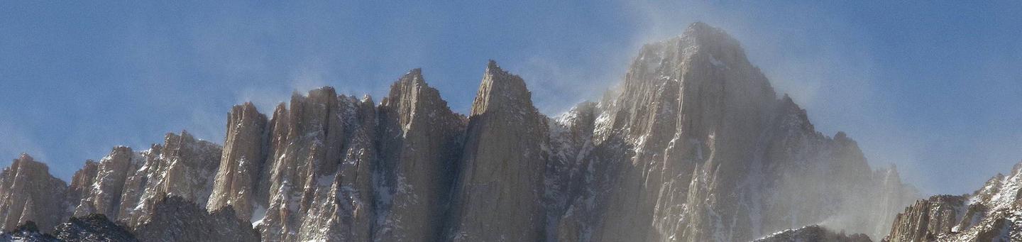 Wind blows snow from the summit of Mount Whitney.The beautiful veil of snow blowing from the summit also indicates the extreme conditions that may be encountered on Mount Whitney.