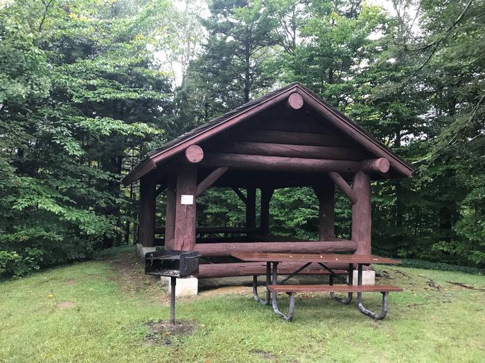 Pavilion with picnic table and grill in wooded areaPicnic Pavilion 2